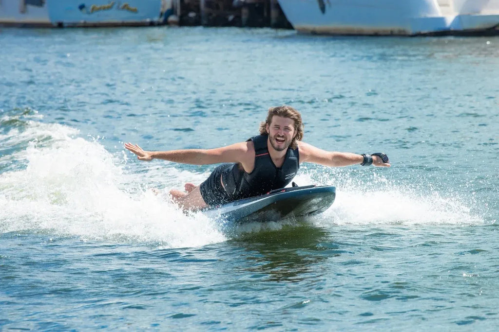 Rider standing on an Awake RÄVIK Explore electric surfboard