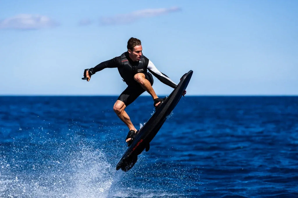 Rider carving on an Awake RÄVIK Ultimate electric surfboard